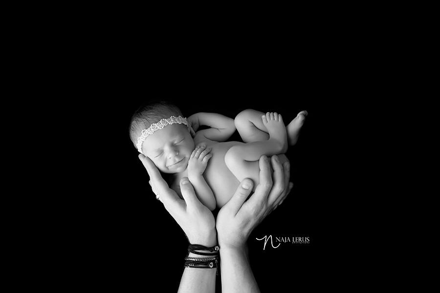 newborn in father's hands chicago IL black and white art