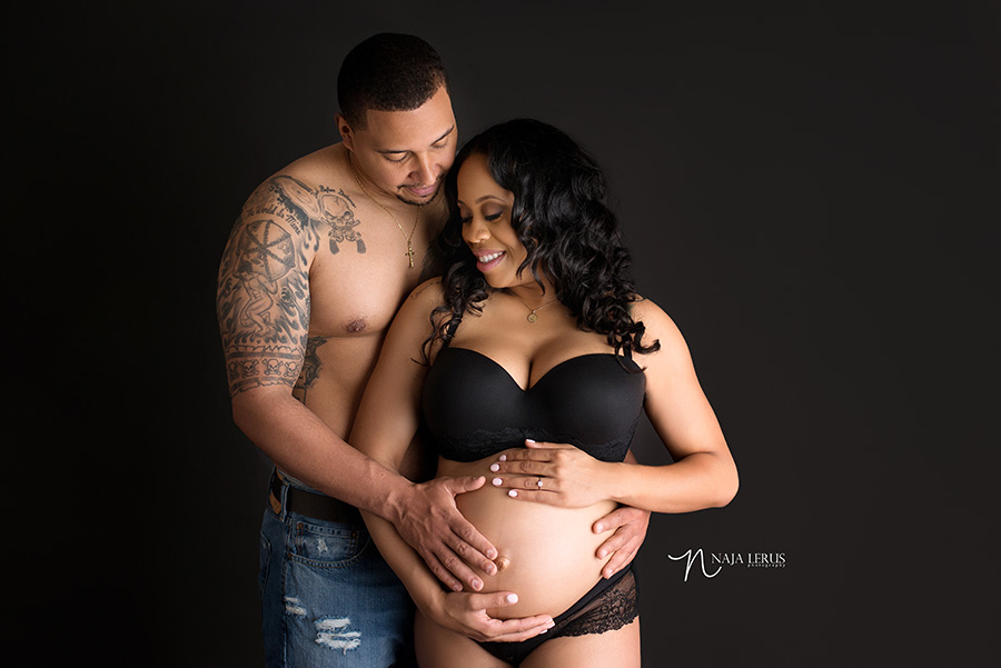 maternity picture with couple together on black