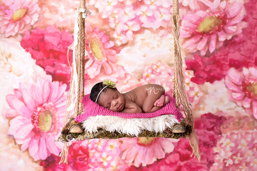 newborn photographer in chicago IL artistic newborn picture with baby on swing chicago IL