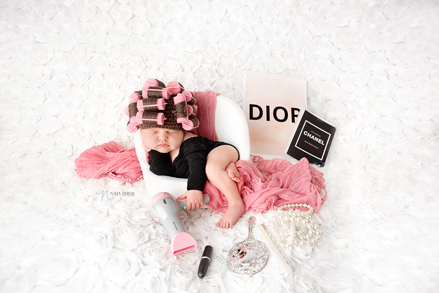 fun newborn photo with curlers in hair and Dior Chanel