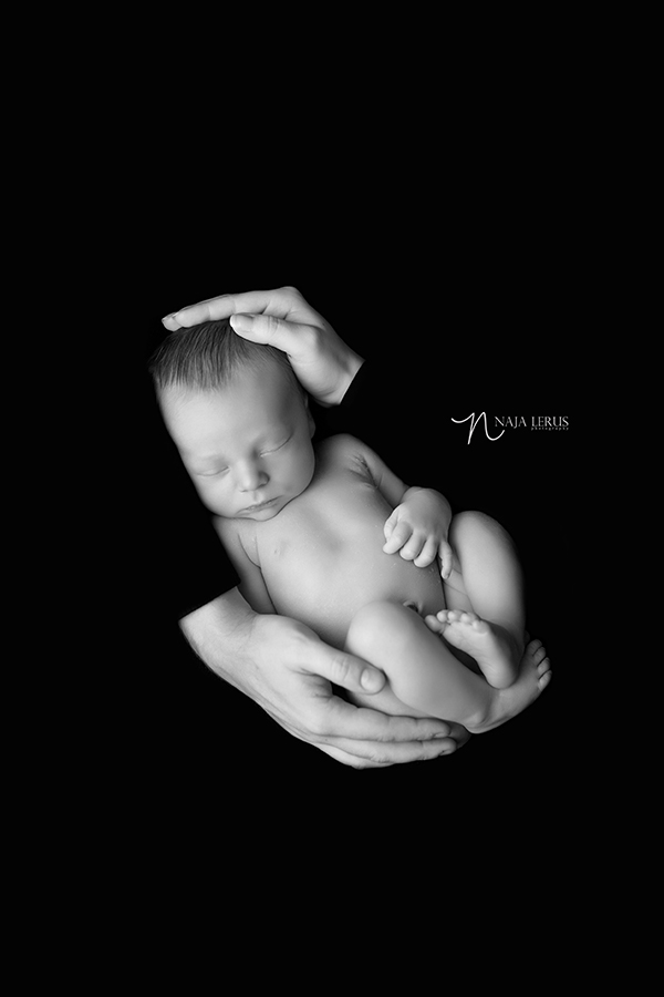 timeless baby in parents hands black and white chicago photographer