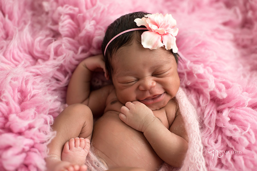 happy newborn baby smiling pose chicago IL