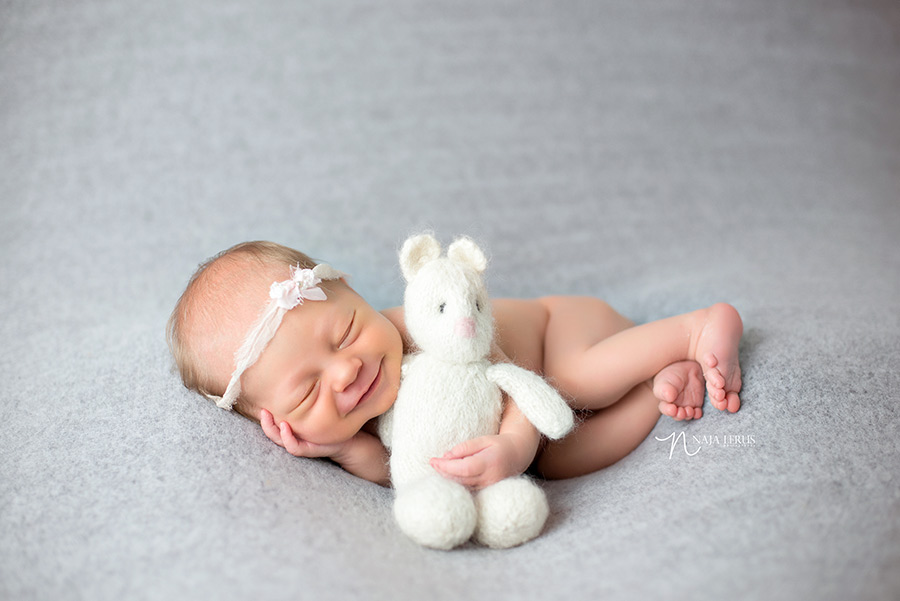 britches and bonnets teddy bear newborn prop with smiling newborn baby chicago