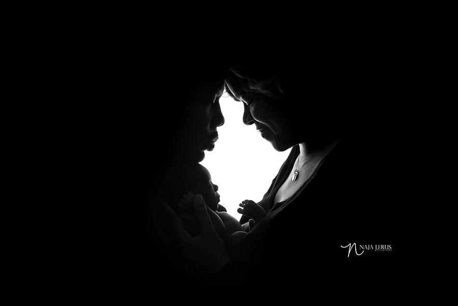 parents newborn shot baby session in silhouette chicago IL