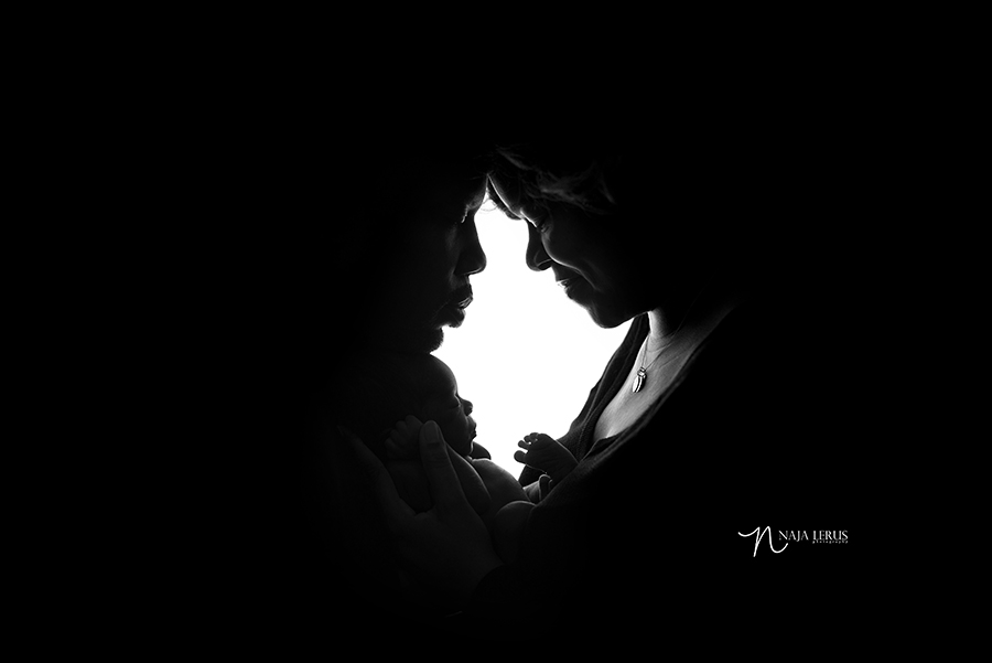 parents newborn shot baby session in silhouette chicago IL