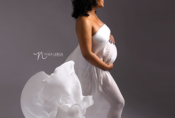 Pregnancy photography chicago IL mother posed with white flowy fabric