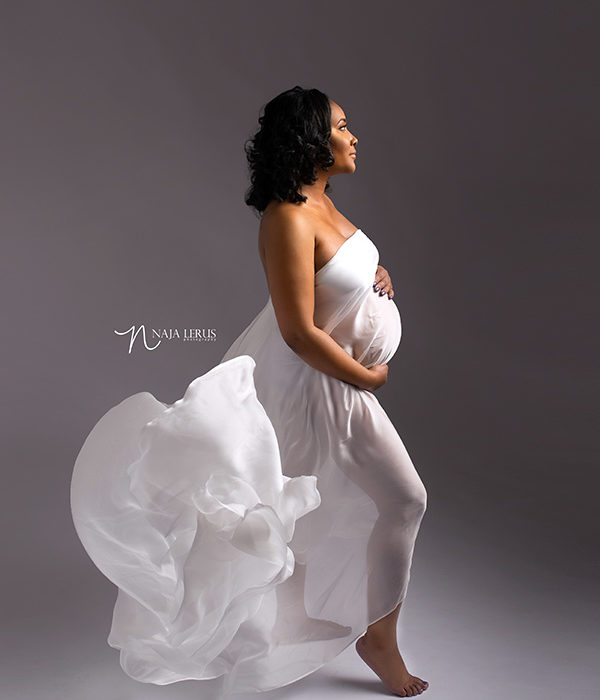 Pregnancy photography chicago IL mother posed with white flowy fabric